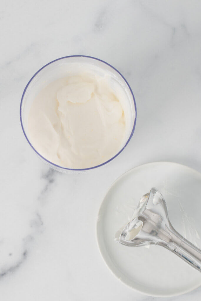 Smooth, creamy whipped ricotta in a food processor after blending with an immersion blender.