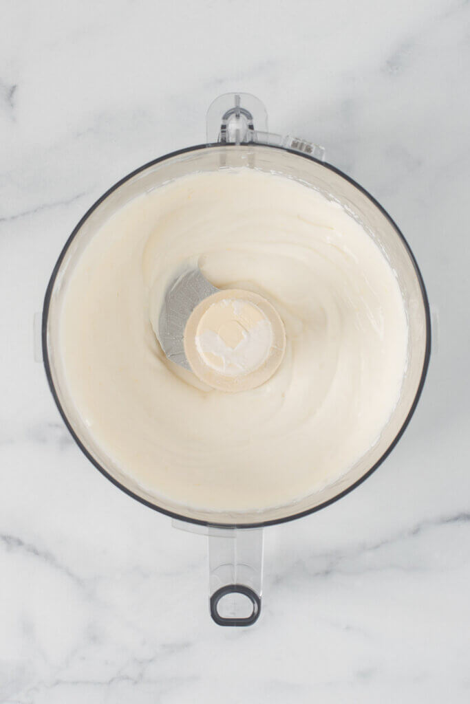 Smooth, creamy whipped ricotta in a food processor after blending.